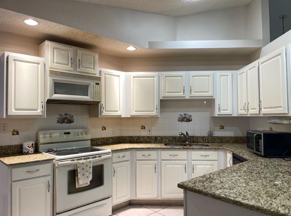 Kitchen features granite counter tops and a SS fridge