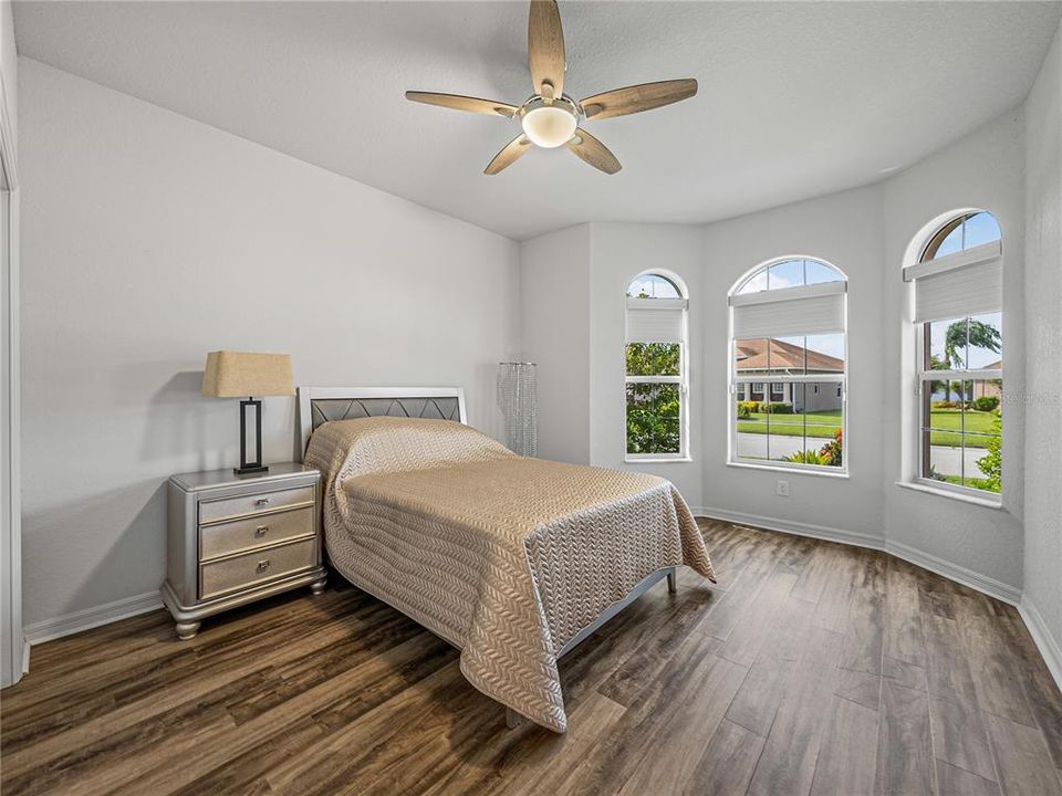 Guest bedroom with bay window at front of home