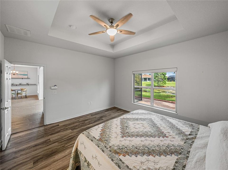 Large window in primary bedroom with a view