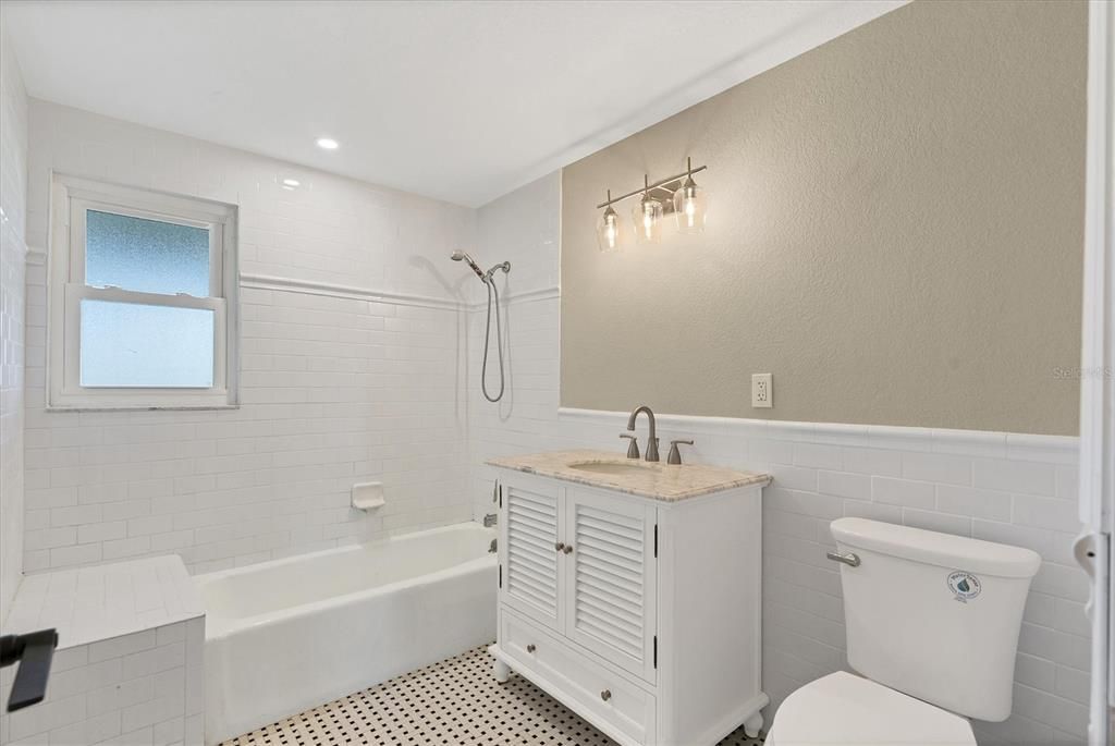 All baths have been updated and feature whimsical basket weave floor tile.