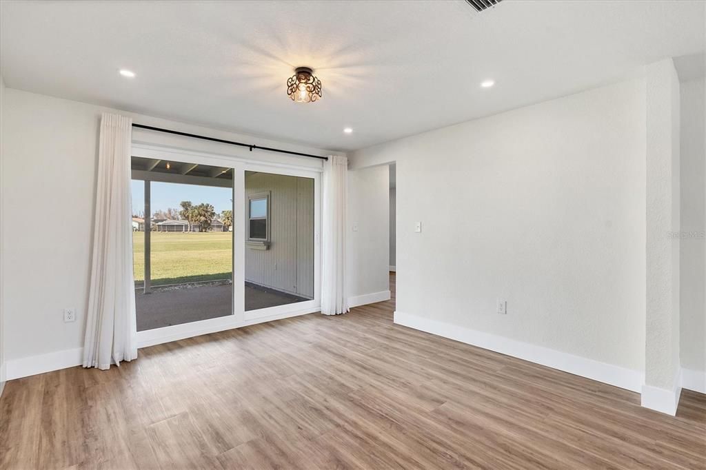 Sliding doors gracefully join the indoor/outdoor living areas, capturing the essence of Florida living.