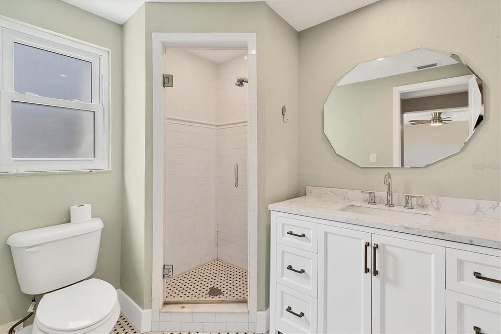 The primary bath offers a furniture-style vanity and a walk-in shower.