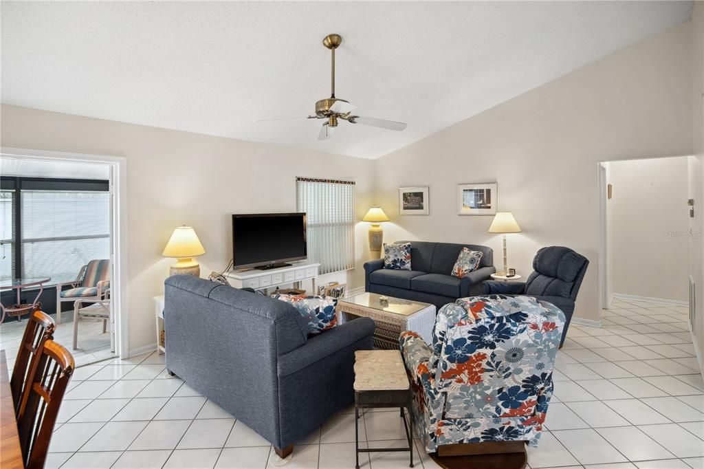 THE LIVING AND DINING ROOM COMBINATION HAS EASY ACCESS TO THE LANAI AND PATIO