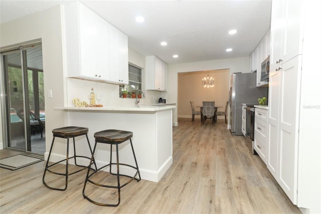 Family room view to kitchen with bar seating