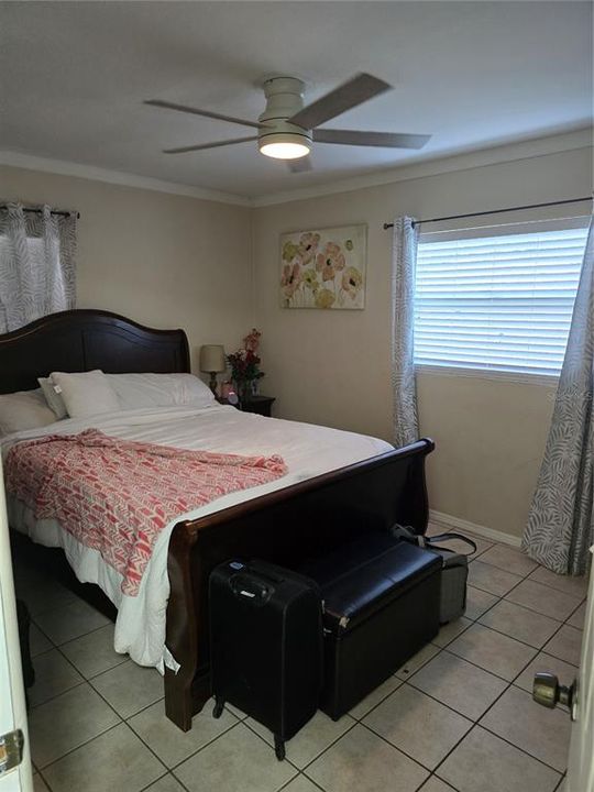 Bedroom 2 (14x11), crown molding, tile flooring, ceiling fan