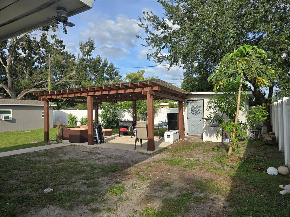 20 x 15 pergola on slab and storage. Backyard fruit trees with vinyl fencing.