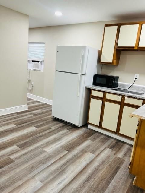 Feb. 2024 Studio apartment. View of kitchen & laminate flooring