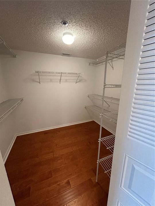 Walk in closet in the primary bedroom