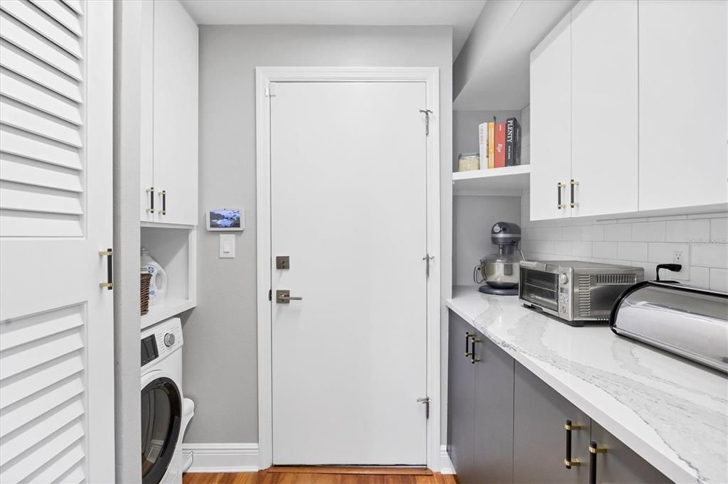 Bonus space off the kitchen with pantry, storage, counter and washer/dryer combo