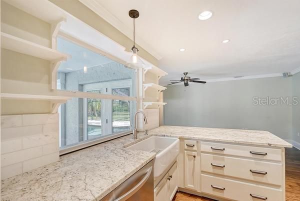 Sumptuous kitchen cabinets with thick granite and big farm sink.