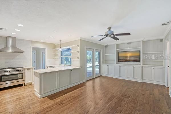 Family room with built-in cabinets, TV and sound system