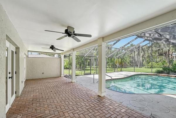 Paver bricked covered lanai for lounging by the pool