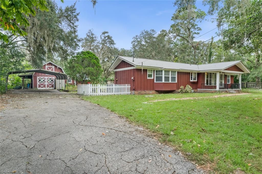 Large Carport and 2 story outbuilding plus laundry room