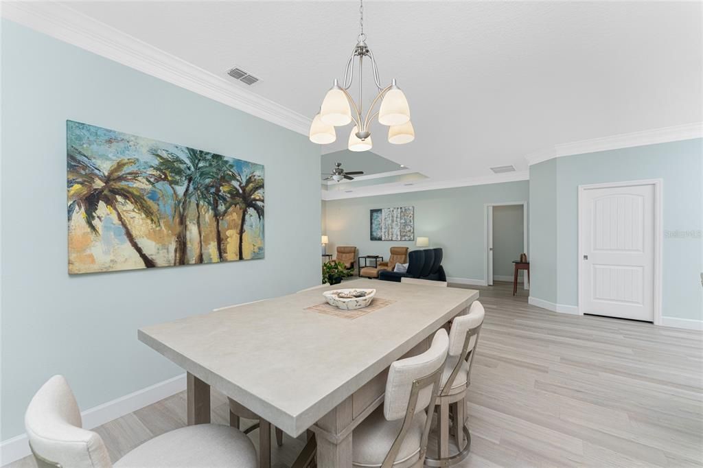 Dining area with lovely overhead lighting and crown molding