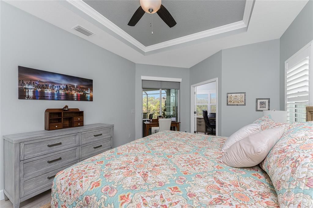 Primary bedroom has sliding glass doors with access to the Lanai