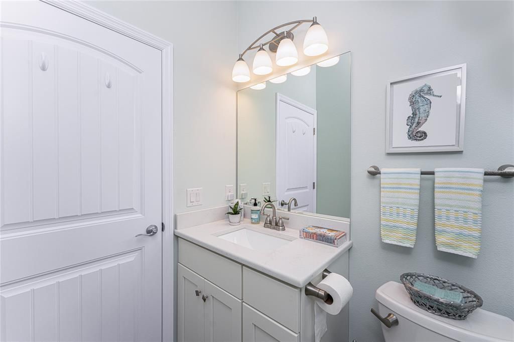 Guest bathroom has a single vanity with Quartz countertop