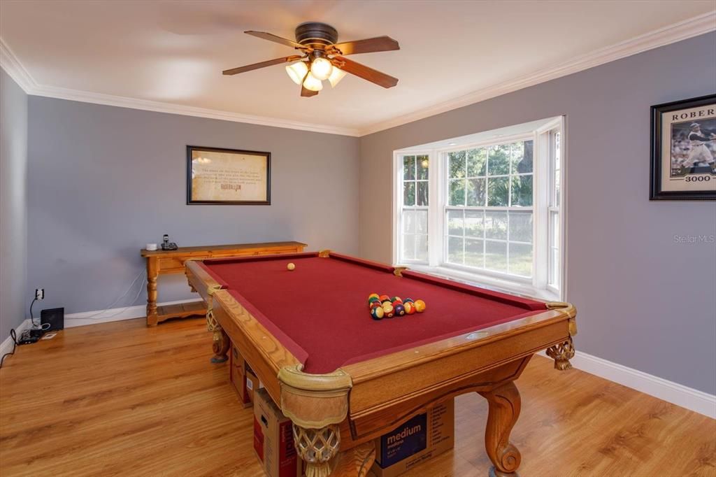 Bay window, crown molding and laminate wood floors in the living room