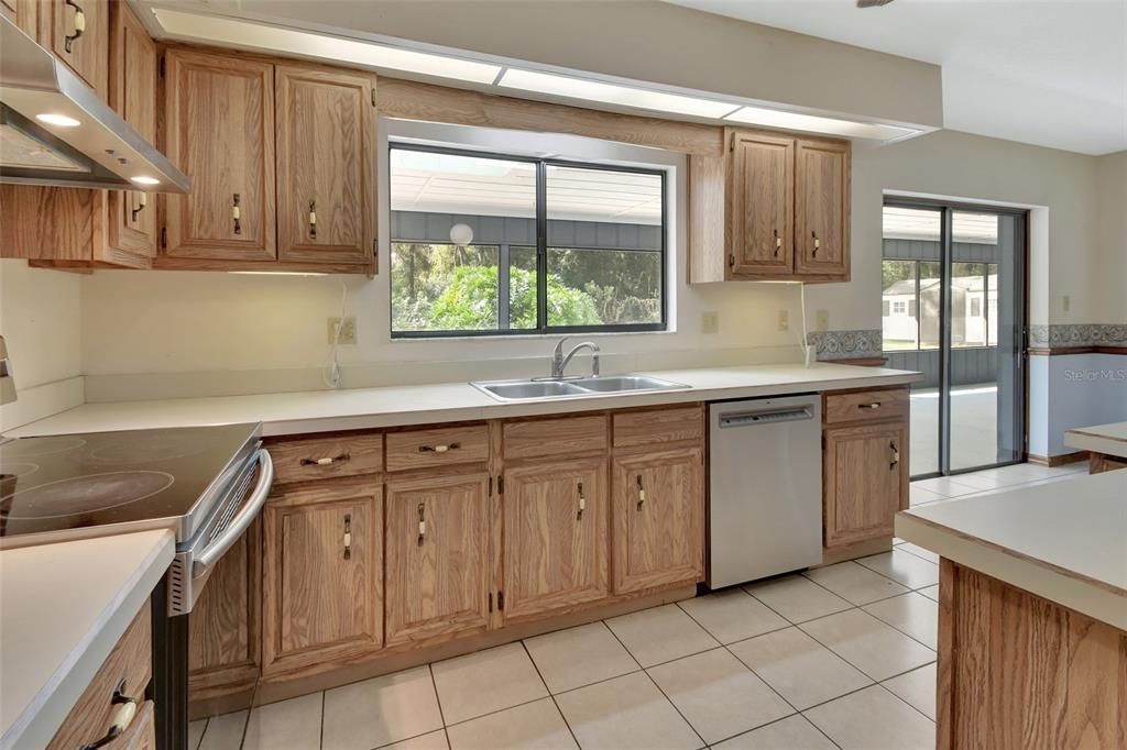 New dishwasher and kitchen window gives view of pool