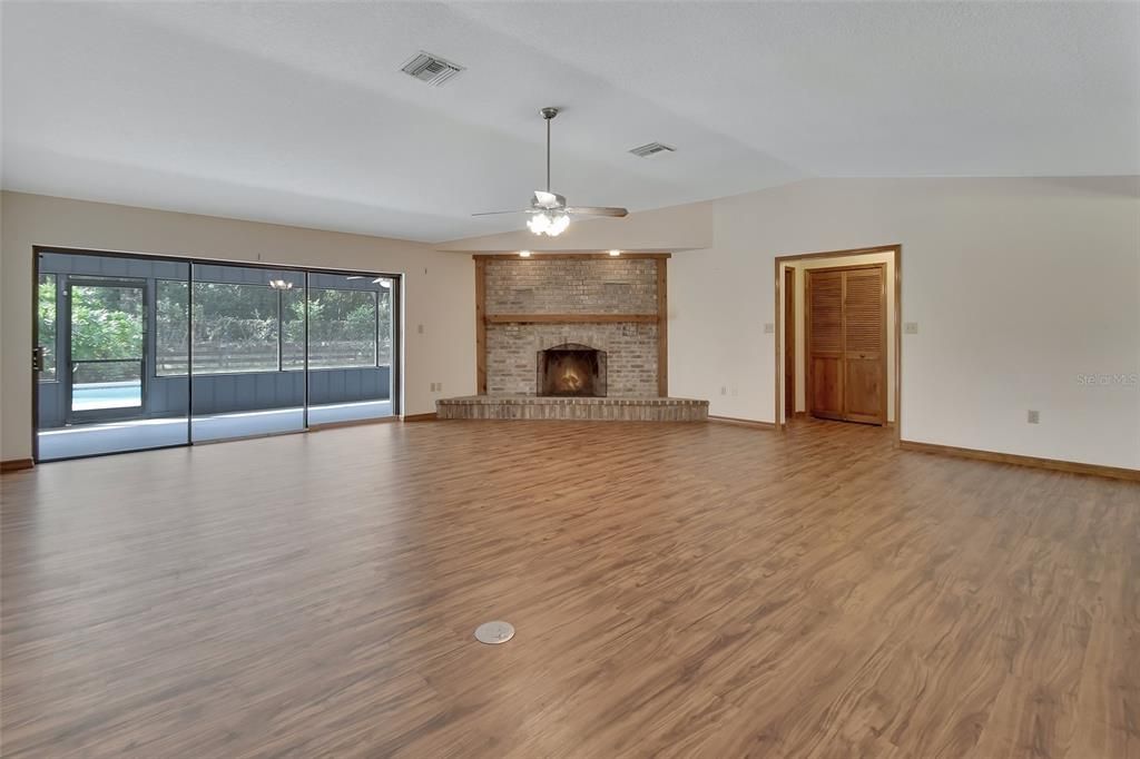 Living Room with fireplace & sliders to lanai-pool