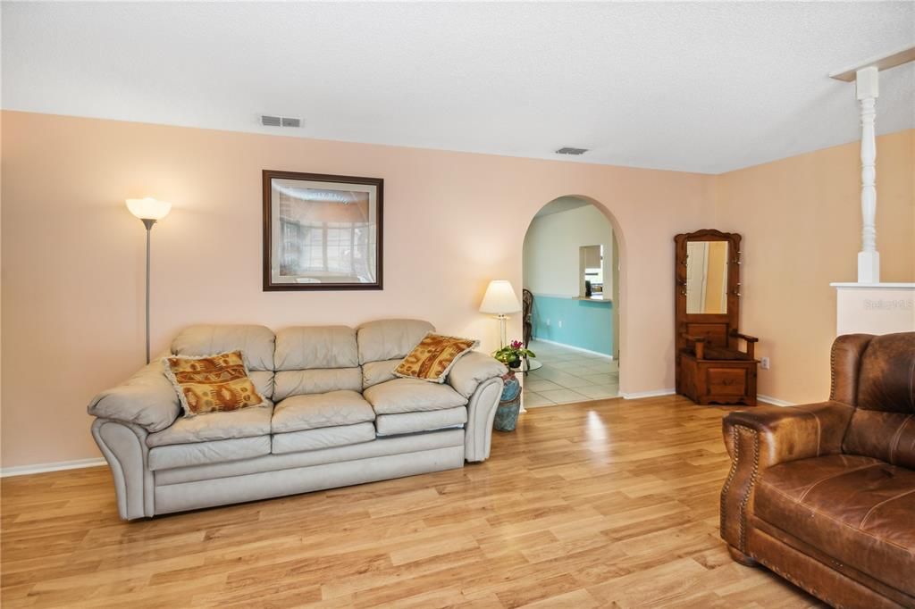 Living room with entry to dining room and kitchen