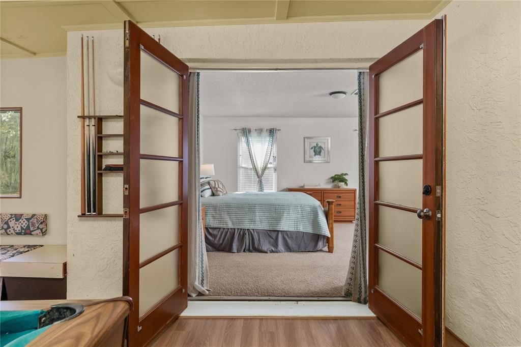 Florida room with French doors leading to the primary bedroom