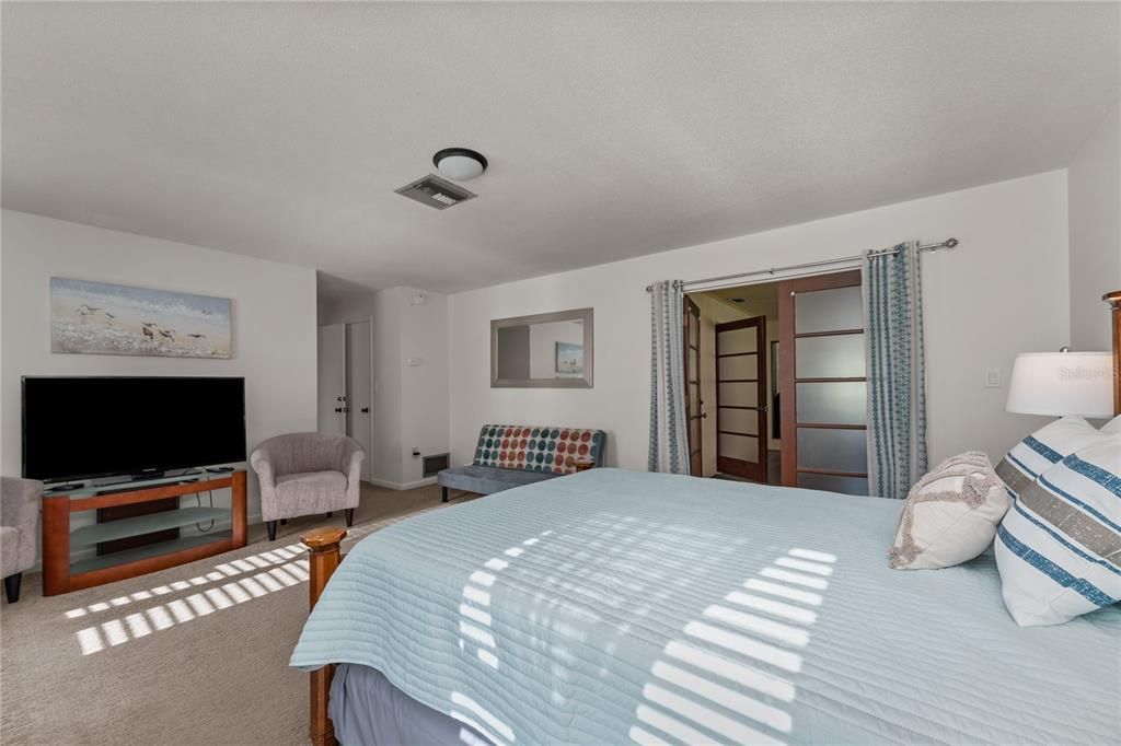 Primary bedroom with French doors leading to the Florida room