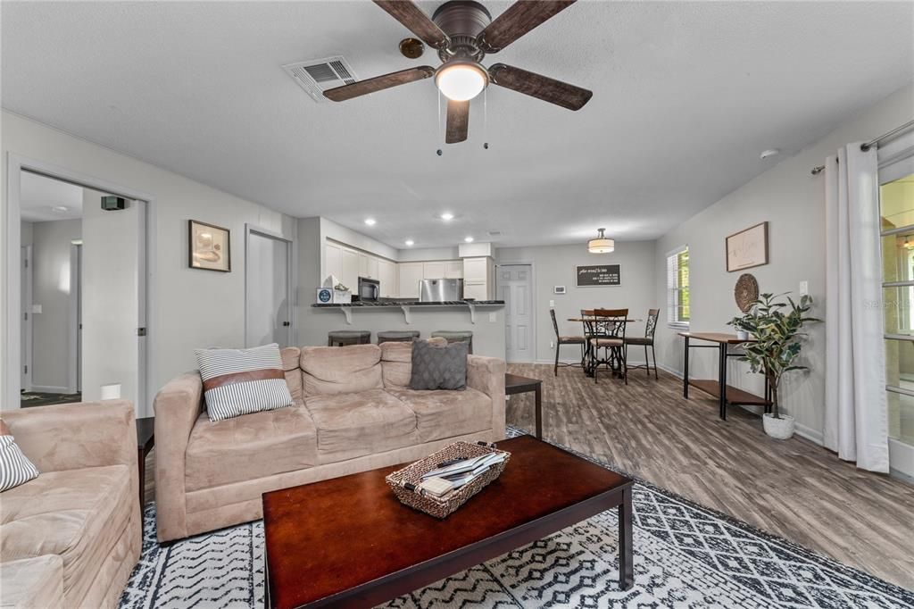 Family room with view of the kitchen and dinette.