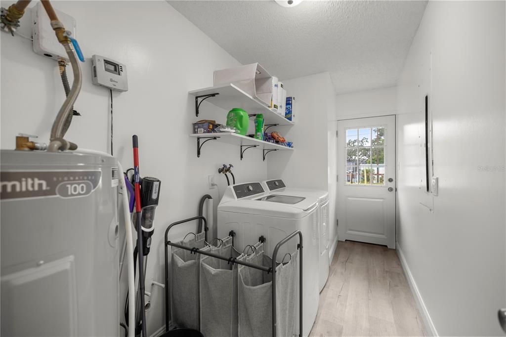 INTERIOR LAUNDRY ROOM WITH NEW HOT WATER HEATER AND APPLIANCES