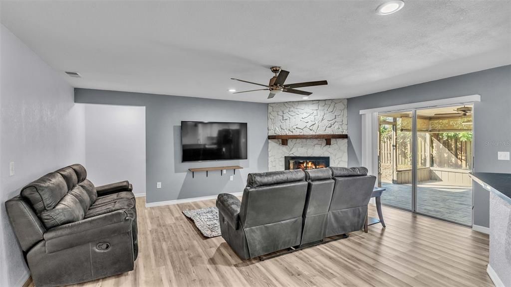 living room with laminate flooring. Sliders to Screened Porch, Stone Wood Burning Fireplace