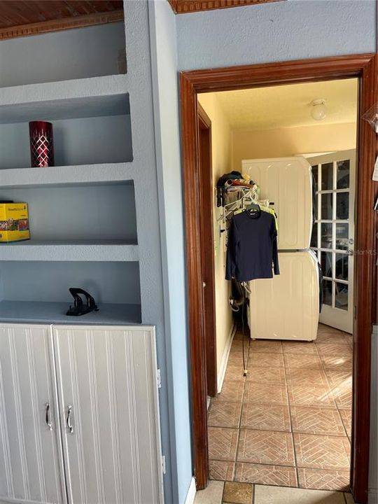 Laundry Area, with white door leading into a big storage room, can be a steam/ Sauna room if desired. The left side of the laundry area leads to the car garage and to the right is a door to the pool/deck.