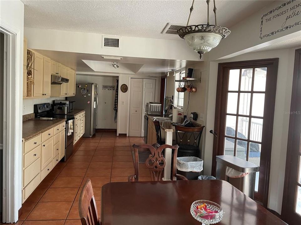 kitchen has pantry closet, door leading to  office.