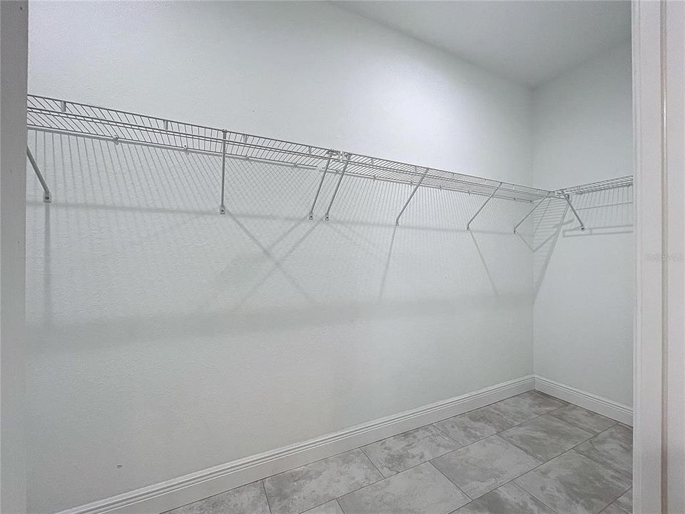 Spacious primary walk-in closet.