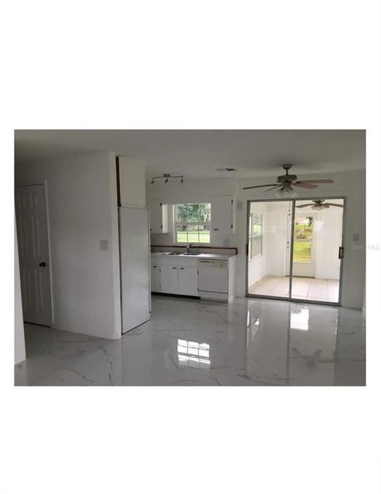 Kitchen and eating space with slider to glass enclosed Florida Room