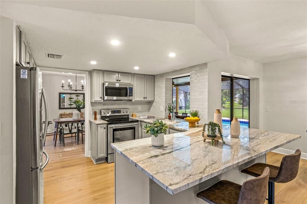 Kitchen with Granite Countertops, subway tile backsplash, stainless steel appliances