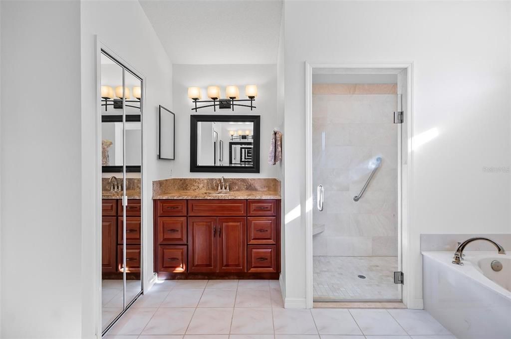 Primary bathroom w double vanities and 2 linen closets