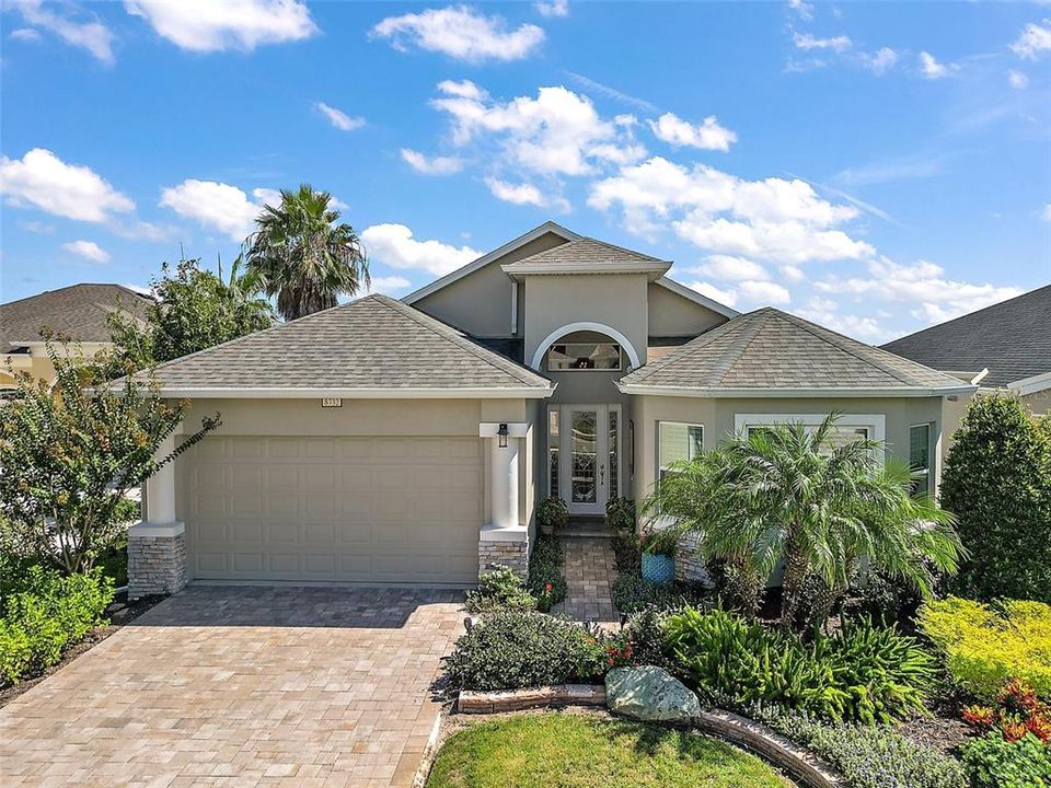 Be inspired at this peaceful home which demonstrates eye catching curb appeal with the paver driveway and lush landscaping.