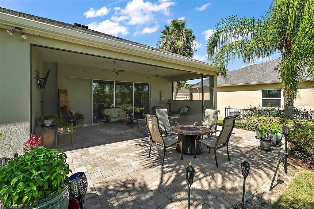 extended open air paver patio offers space to house a firepit, seating and BBQ grill.