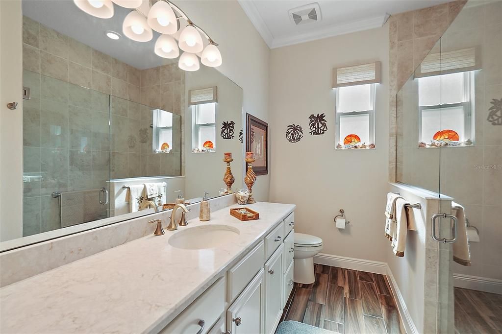 Hall bath with quartz countertop and beautiful walk in shower.