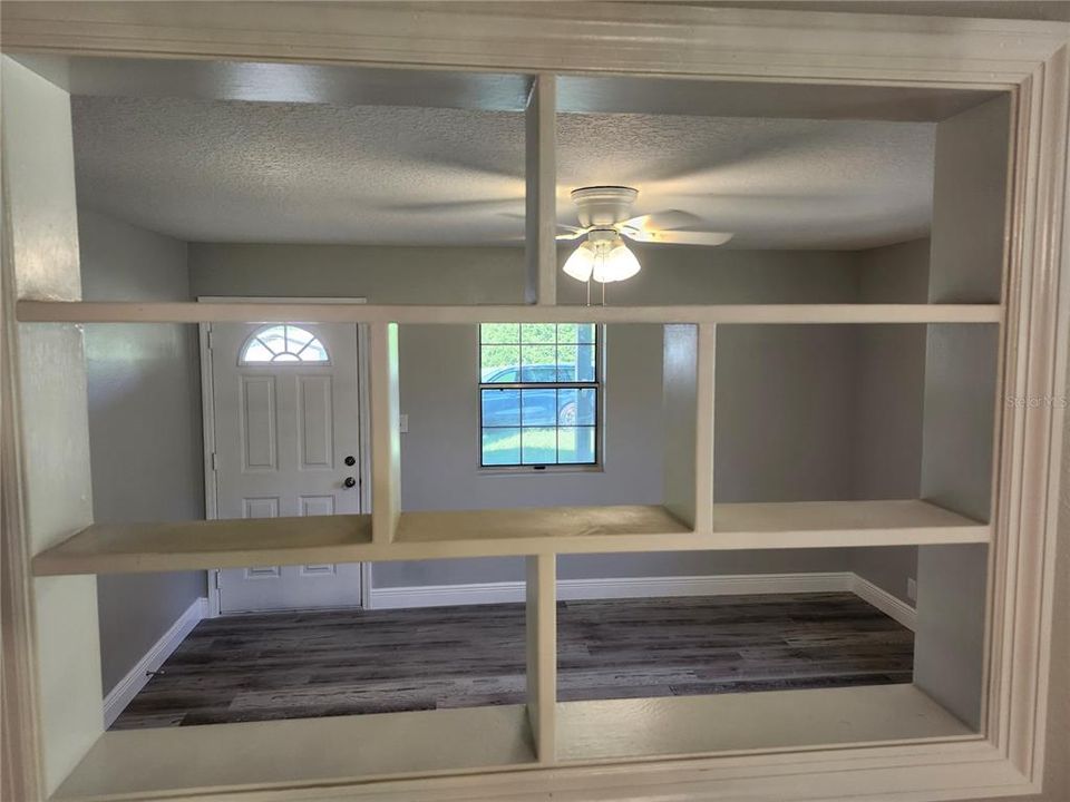 View into Living Room from wall shelf in Dining Room