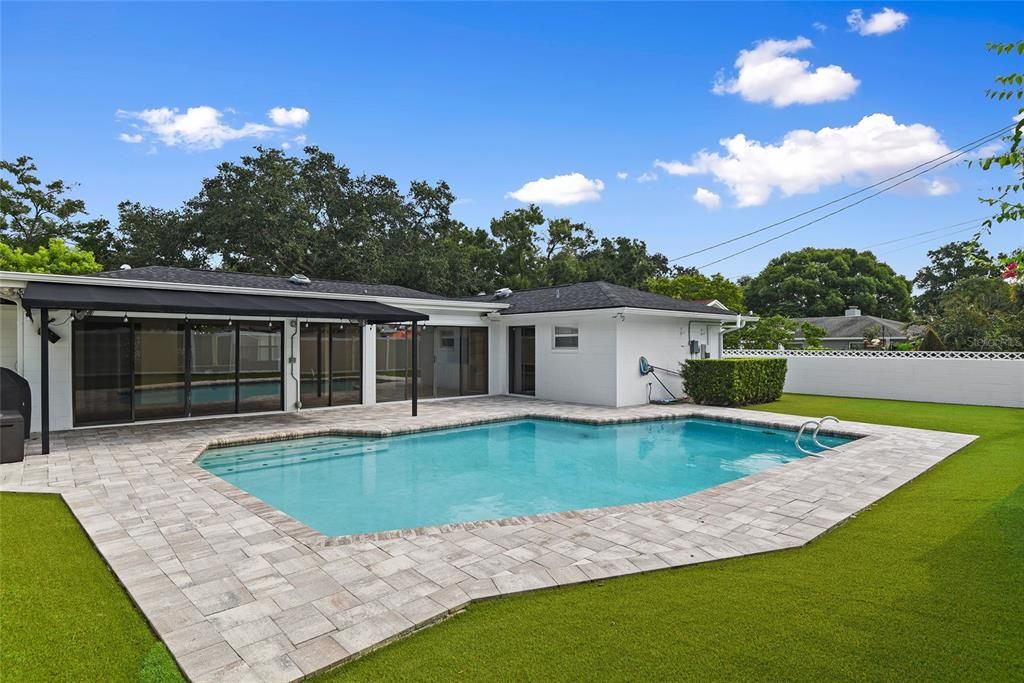 Resurfaced pool surrounded by turf grass