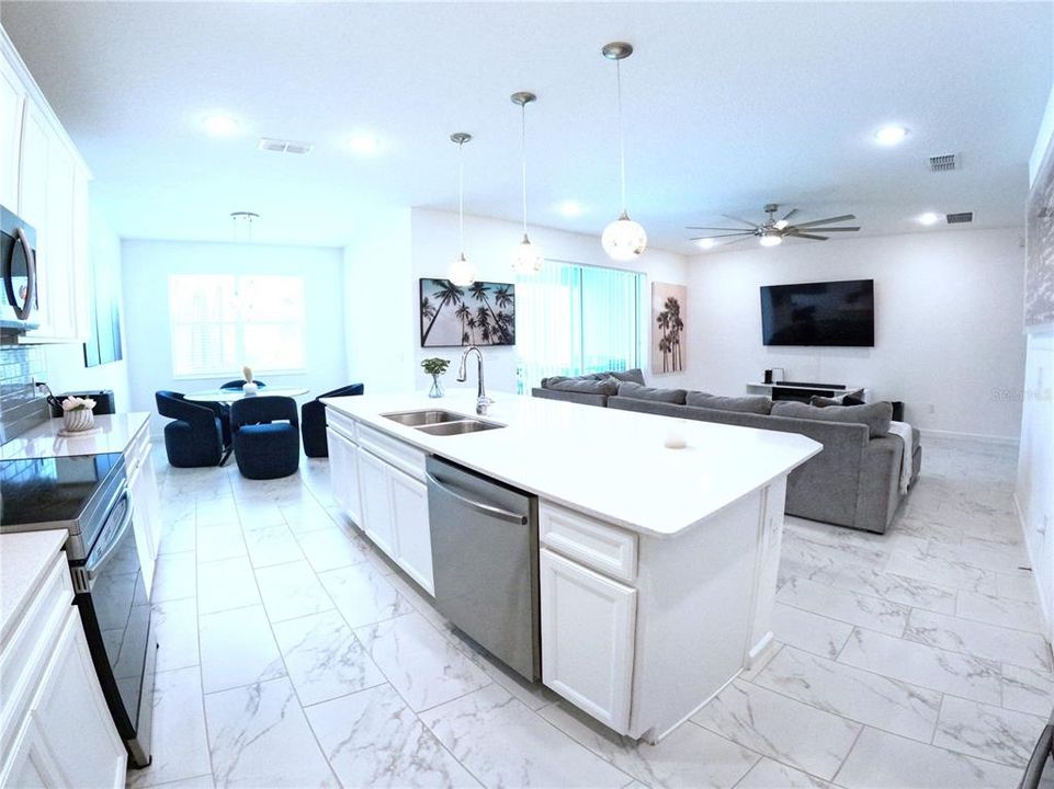 White on white stone countertops with stainless steel appliances