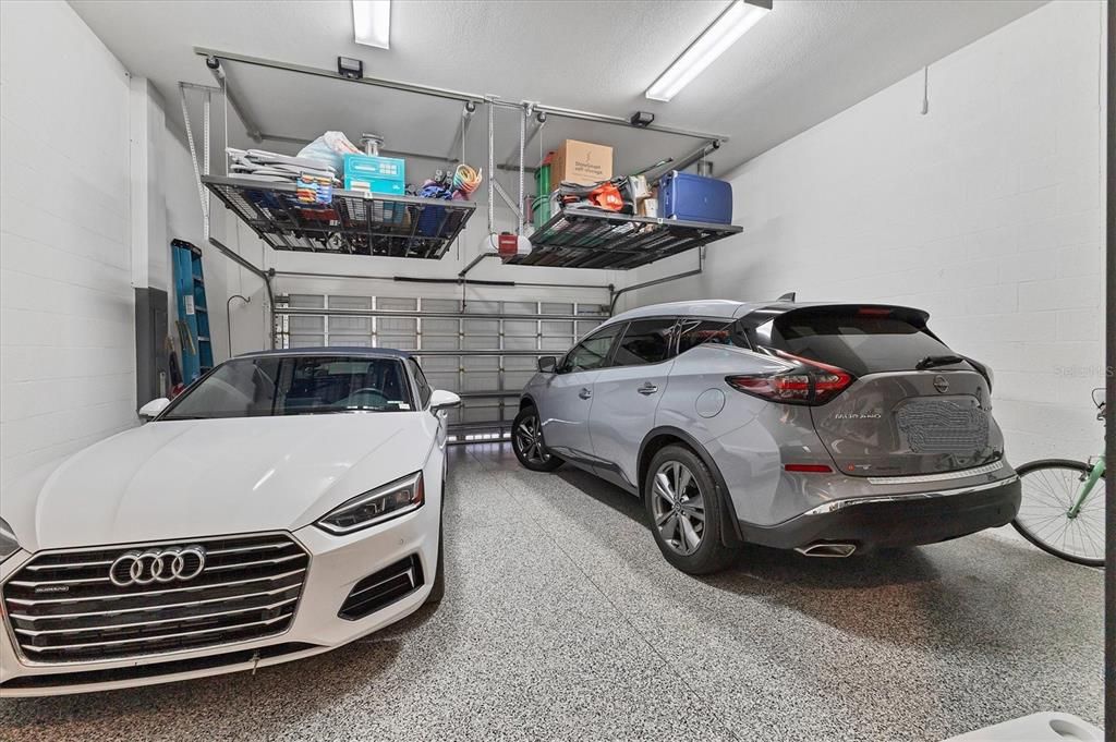 Garage with 2 storage lifts and cabinetry!