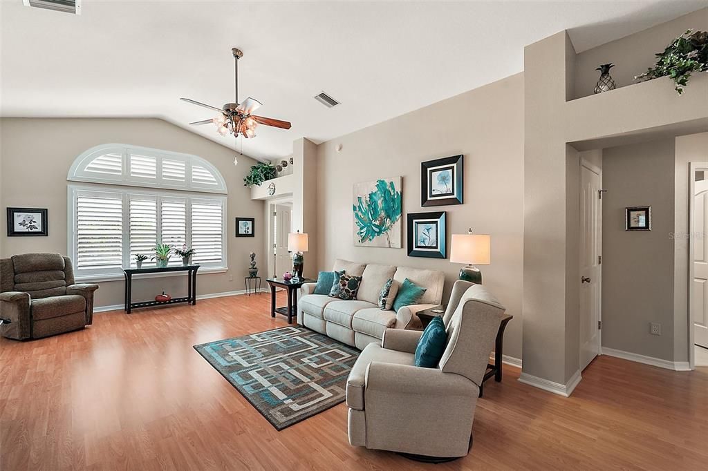 Living room bathed in natural light with high ceilings.