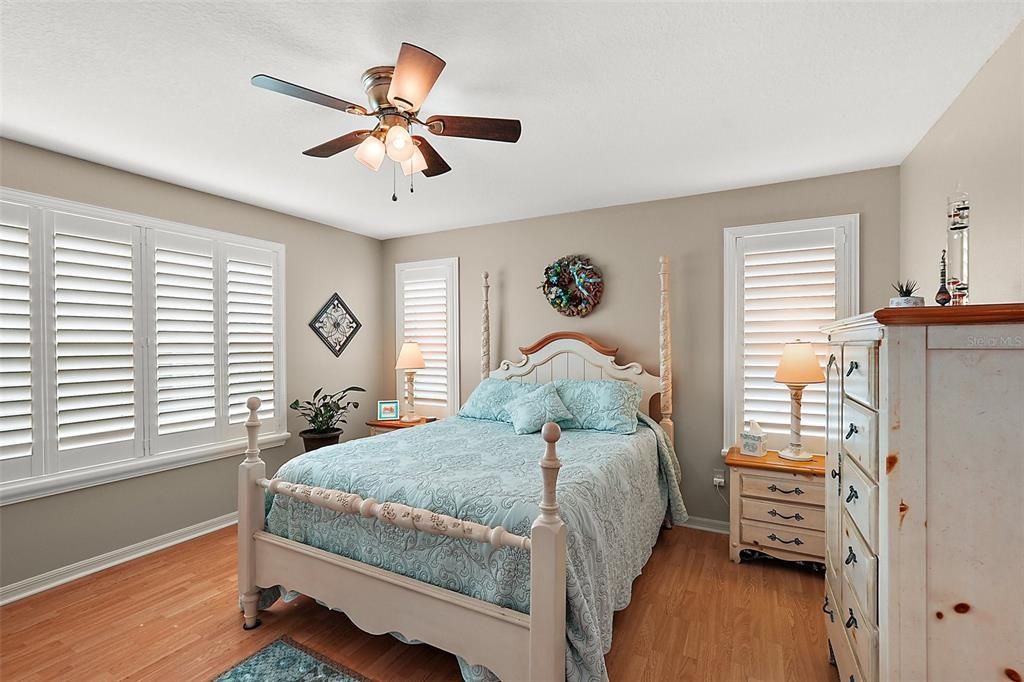 Primary bedroom with plantation shutters.