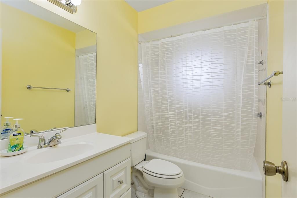 Guest bathroom has a shower tub combo.