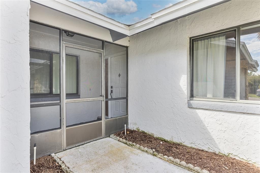 The entry way has a small screen enclosure that would make a great place for plants and home decor.