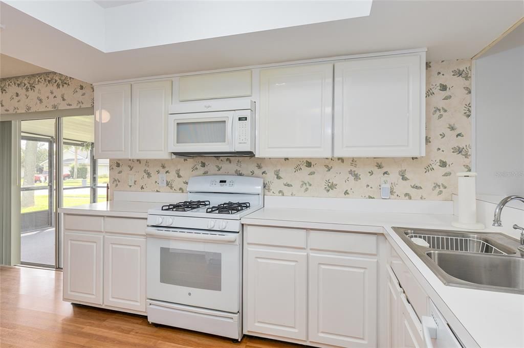 Sliding glass doors off to the side of the kitchen go out to the huge screened in porch.