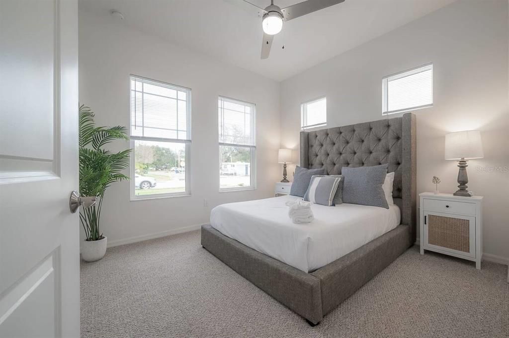 Bedroom 3 with queen-size bed and four windows to allow lots of natural light.