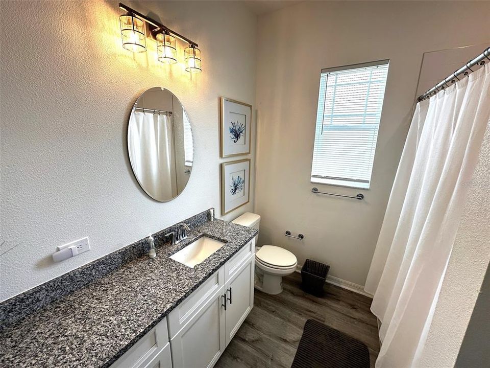 Bathroom 2 with tub and shower located between bedrooms two and three.