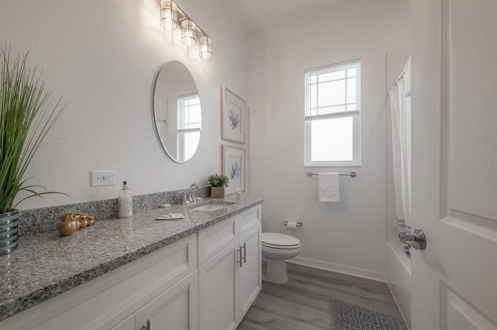 Bathroom 2 with tub and shower located between bedrooms two and three.